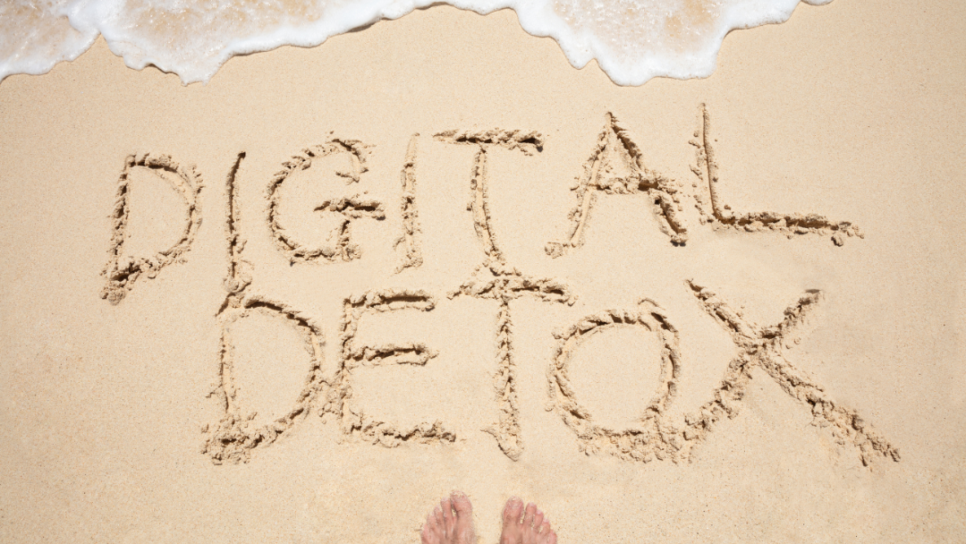 Digital Detox written in sand on a beach